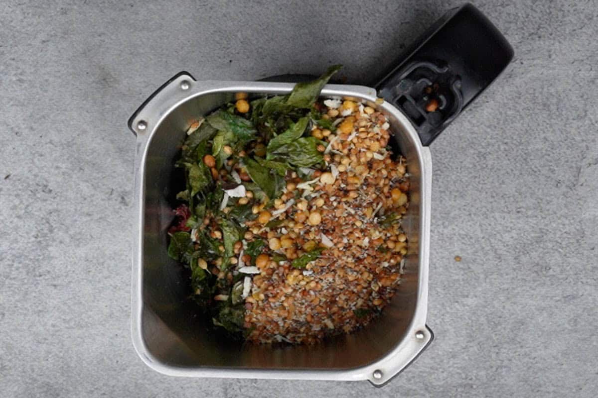 Roasted ingredients added to a grinder.