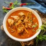 Mutton Kulambu (Mutton Kuzhambu) is a spicy village-style mutton curry famous in India's Chettinad region. It can be made in a traditional stovetop pressure cooker or instant pot. Make it using my easy recipe.