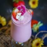 This creamy Strawberry Banana Milkshake is a delicious breakfast treat made with fresh or frozen strawberries. It can be made with or without ice cream.
