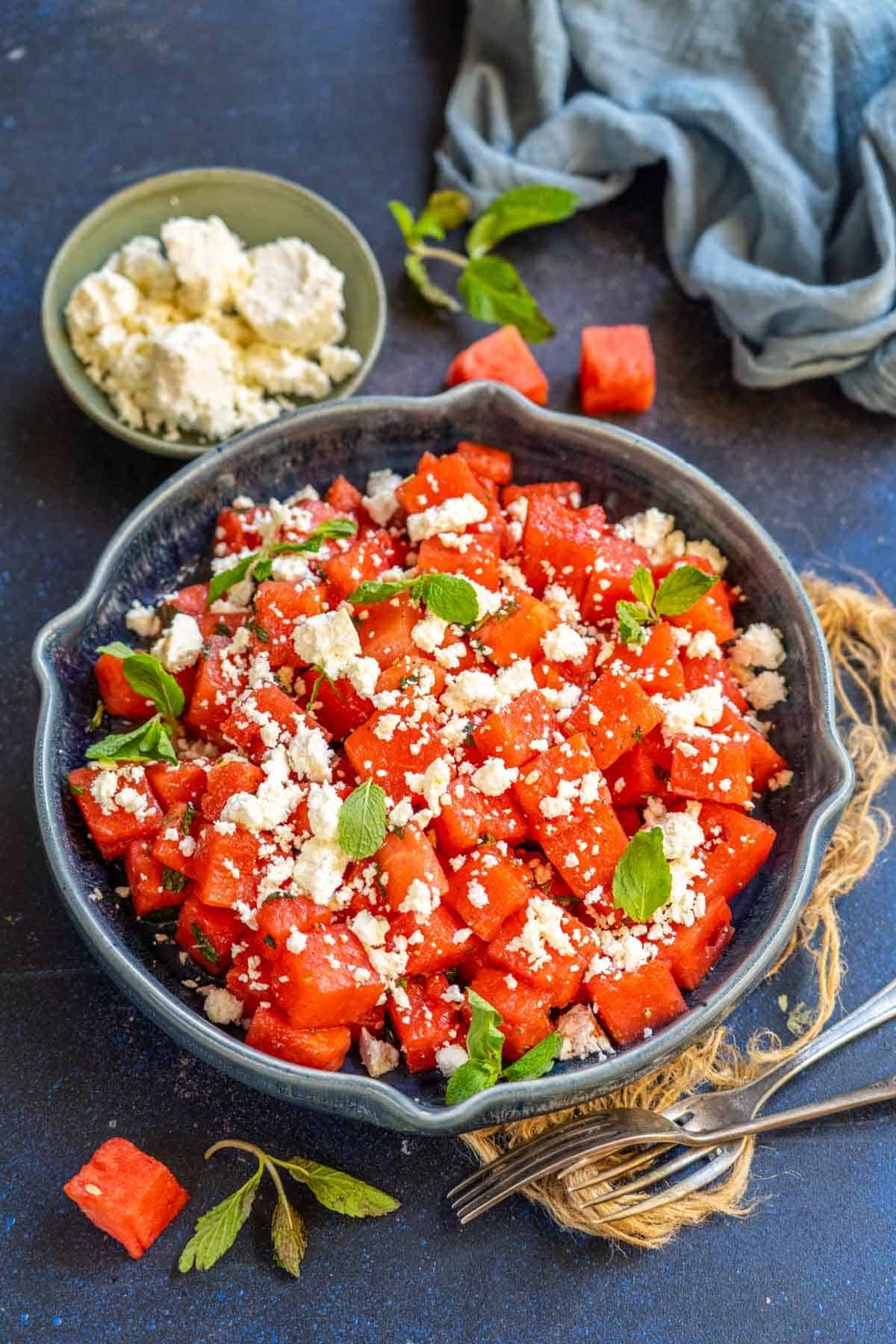 Watermelon Feta Salad added to a bowl.