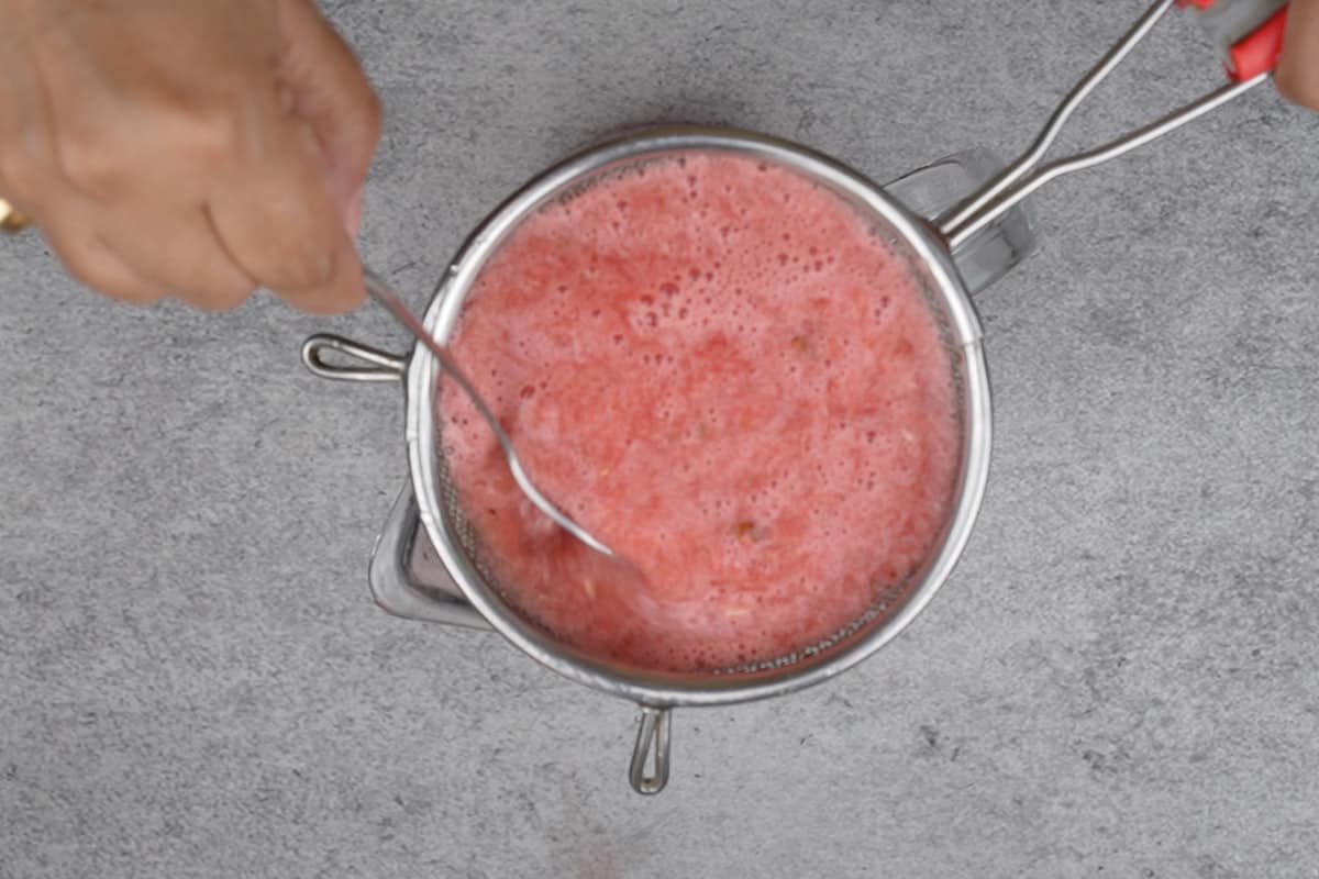 Juice passes through a strainer.