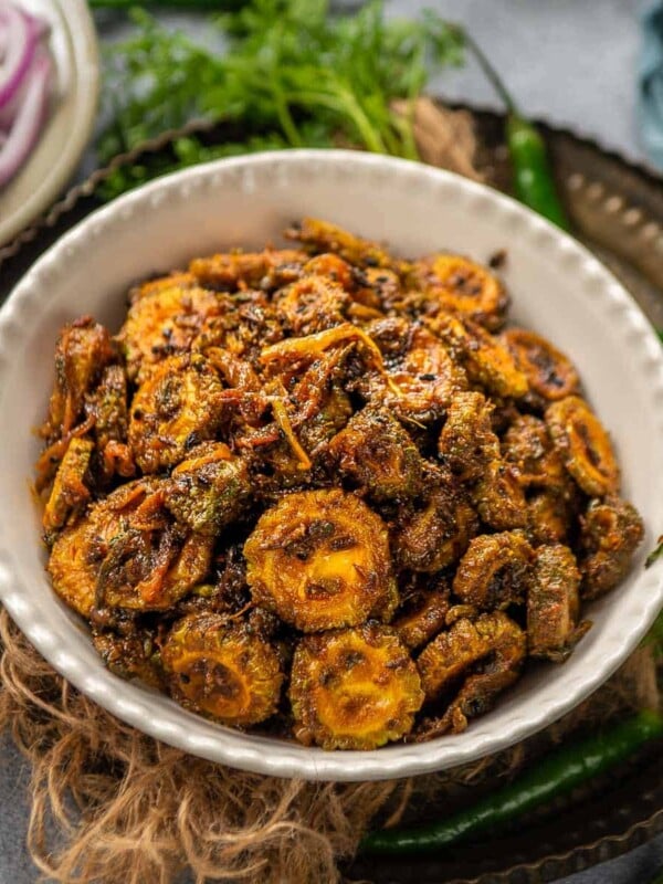 Try this spicy, tangy, and sweet masaledar karela for your everyday Indian meals. It tastes great with Phulka, Paratha, or even with Dal Rice. Here is how to make it. (vegan, gluten-free)