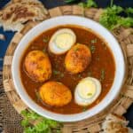 This Punjabi Egg Curry (Anda Curry) is a flavorful curry where hard-boiled eggs are simmered in an onion- tomato based gravy. Make it in under 30 minutes using simple ingredients (gluten-free).