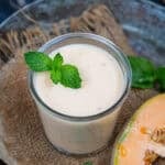 Cantaloupe banana smoothie served in a glass.