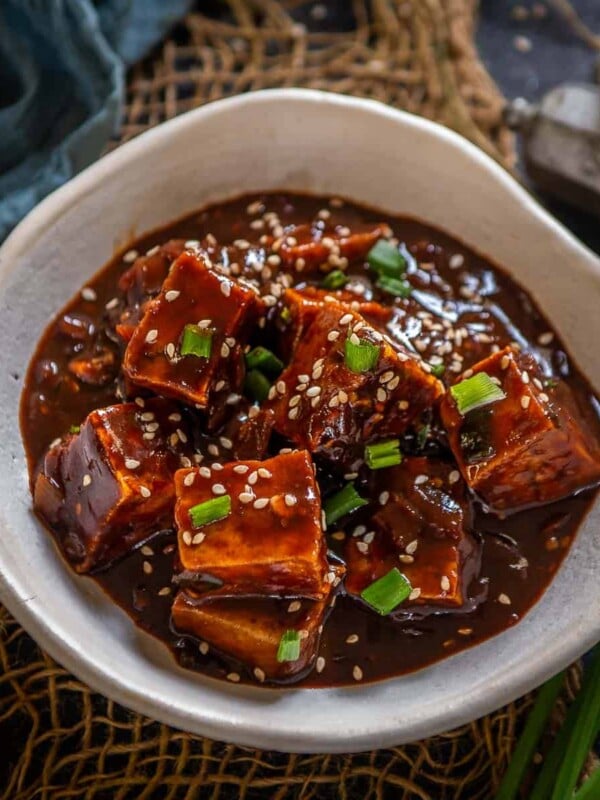 Korean Gochujang Tofu is a vegan and gluten-free dish where tofu is baked or fried until crisp from outside and then mixed with a savory spicy sauce. Make this easy and delicious dish at home instead of an expensive take-out.