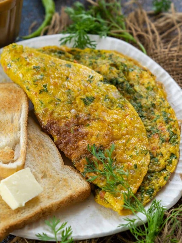 Indian Masala Omelette is a spicy desi-style omelet recipe that comes together in under 10 minutes. Serve it with bread, toast, chapati, or paratha for a healthy treat (gluten-free).