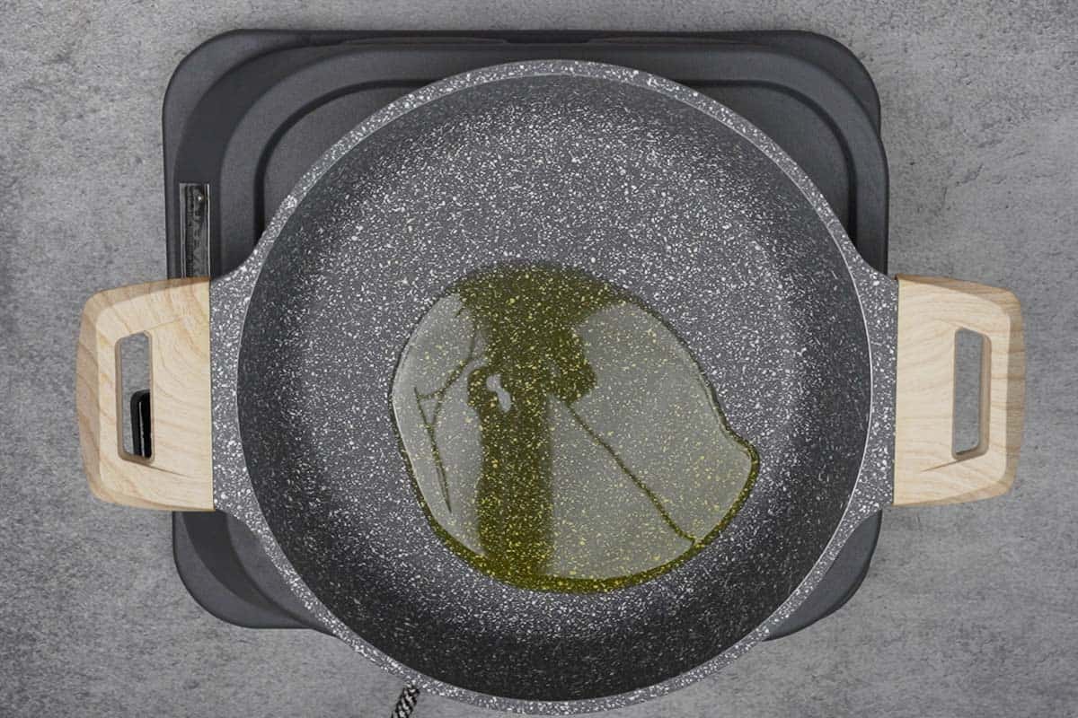 Extra virgin olive oil heating in a pan.