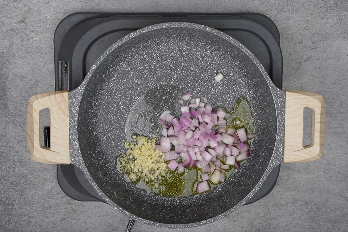 Onion and garlic added to the pan.