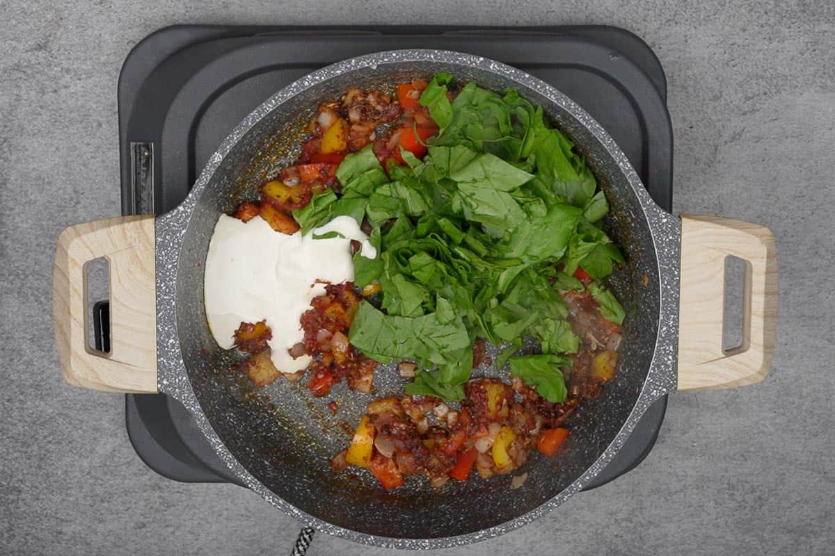 Spinach and heavy cream added to the pan.