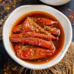 Bharwa Lal Mirch Ka Achar (Stuffed Red Chilli Pickle) is a traditional hot, spicy, tangy North Indian pickle made using thick red chilies and Indian pickling spices. I am sharing my mom's signature foolproof recipe to make this lal mirch ka bharwa achar (vegan).