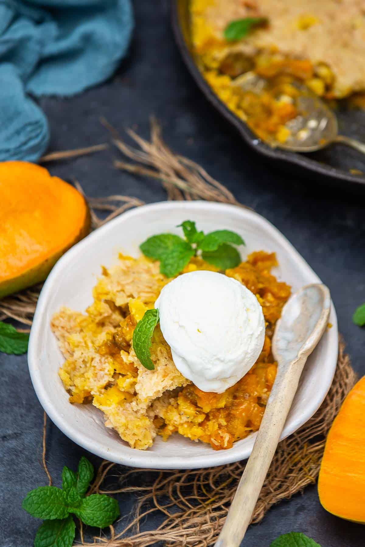 Mango cobbler served in a bowl.
