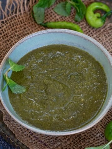 This Mint Chutney (Pudina Chutney) is a great accompaniment to your stuffed parathas, pakoras, biryanis, and chaat. Make this refreshing chutney using my easy recipe (vegan, gluten-free).