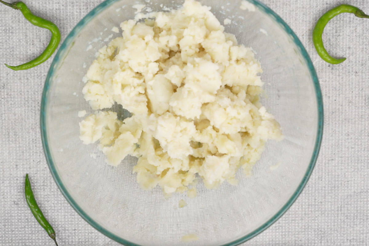 Boiled potatoes mashed in a bowl.