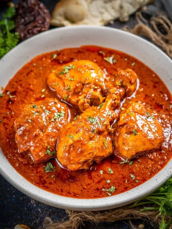 Vindaloo is a Portuguese-influenced Goan dish made by cooking meat with spices and vinegar. Learn to make chicken vindaloo in a traditional way using my easy recipe.