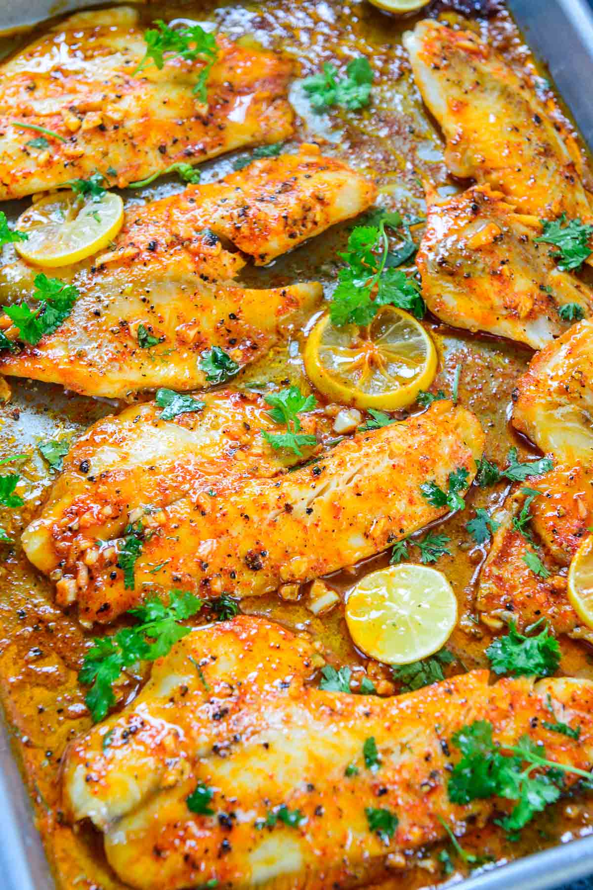 Spicy lemon garlic tilapia served on a tray.