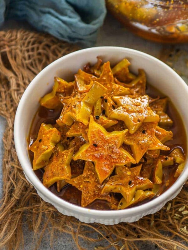 Starfruit Pickle (Kamrak Ka Achar) is a different and unique Indian pickle recipe that you need to try this summer! It is just like your green mango pickle but with the goodness of starfruit. It is easy, addictive, and requires a few basic pantry ingredients (vegan, can be easily made gluten-free).