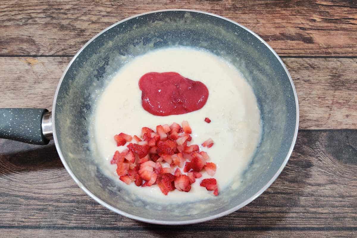 Strawberry puree and chopped strawberries added to the pan.