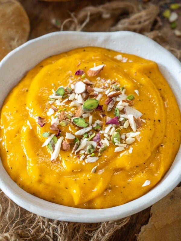 Aamras is a popular Indian dessert made using fresh ripe mangoes, milk, sugar, and ground cardamom. Serve it on its own as a dessert or with puffed puri for a hearty meal (gluten-free, can be easily made vegan).