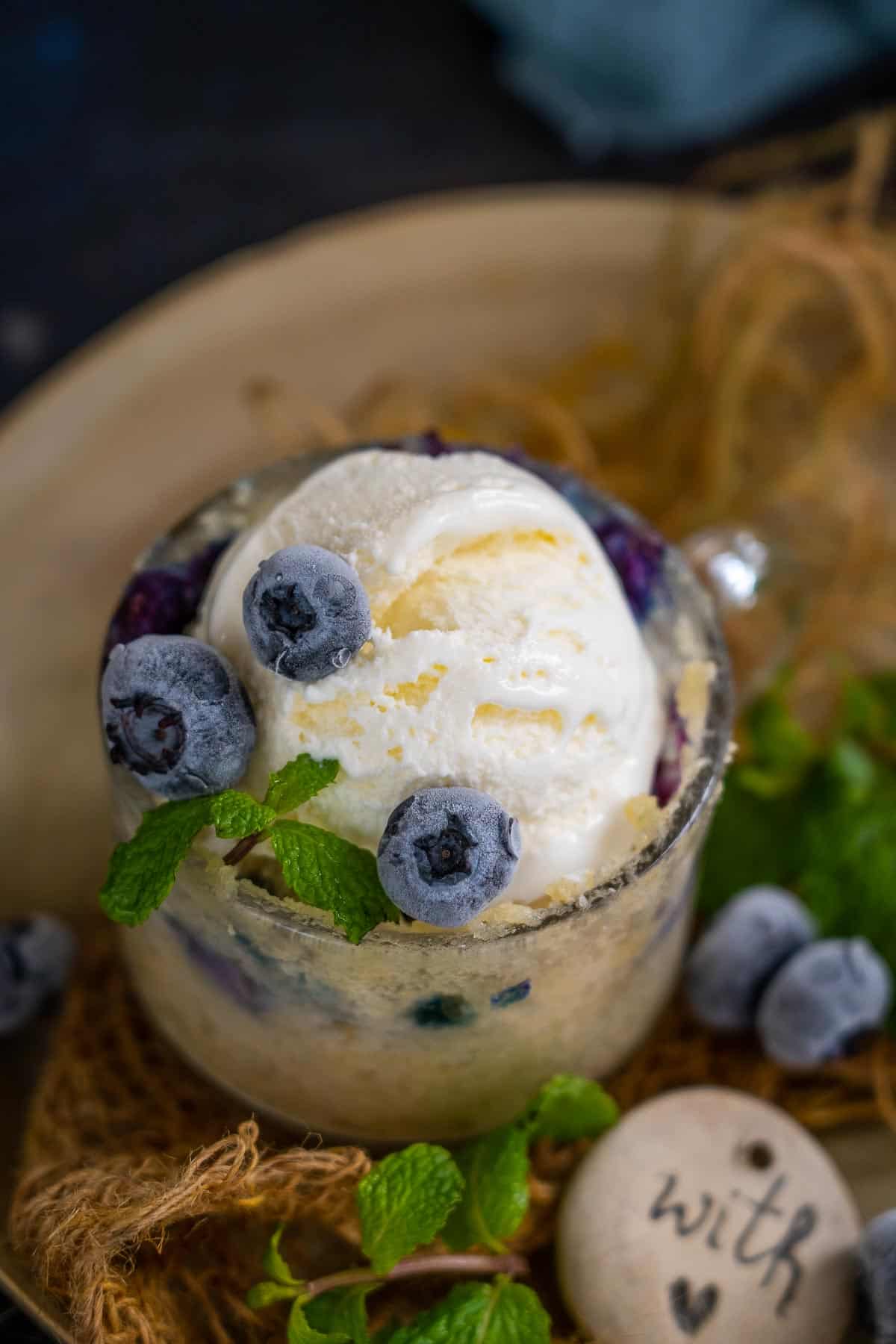 Blueberry muffin mug cake served with ice cream.