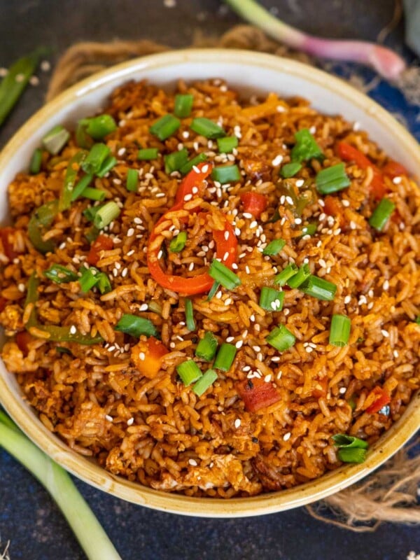 This Korean Gochujang Fried Rice comes together in just 15 minutes and makes for a great main course or side dish. Load it up with veggies, eggs, bacon, or meat of your choice for a spicy treat.