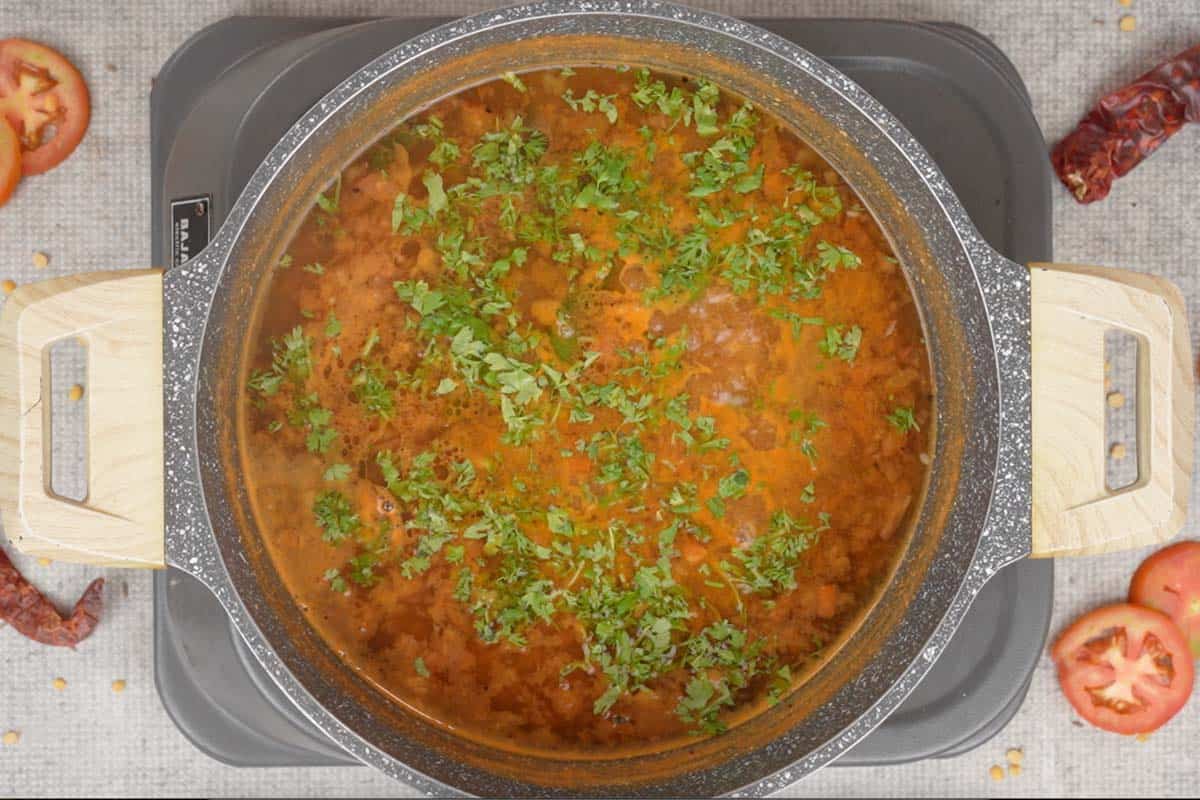 Chopped cilantro added to rasam.