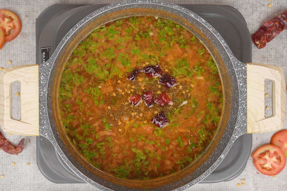 Tempering poured over ready tomato rasam.