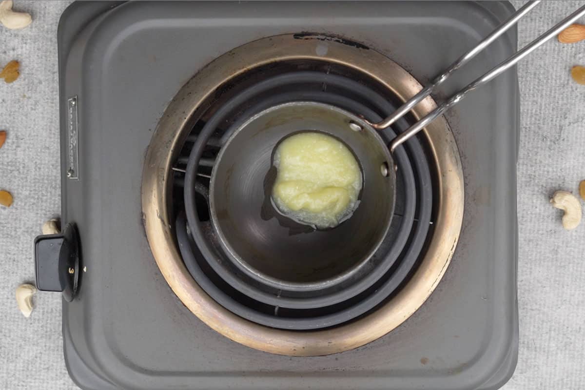 Ghee heating in a small pan.