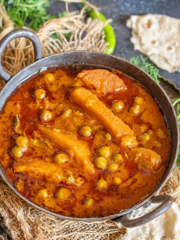 Make this spicy Punjabi-style Aloo Matar Curry (Green Peas Potato Curry) at home using my easy recipe. You can make this recipe in a traditional stovetop pressure cooker or in an instant pot (vegan, gluten-free).