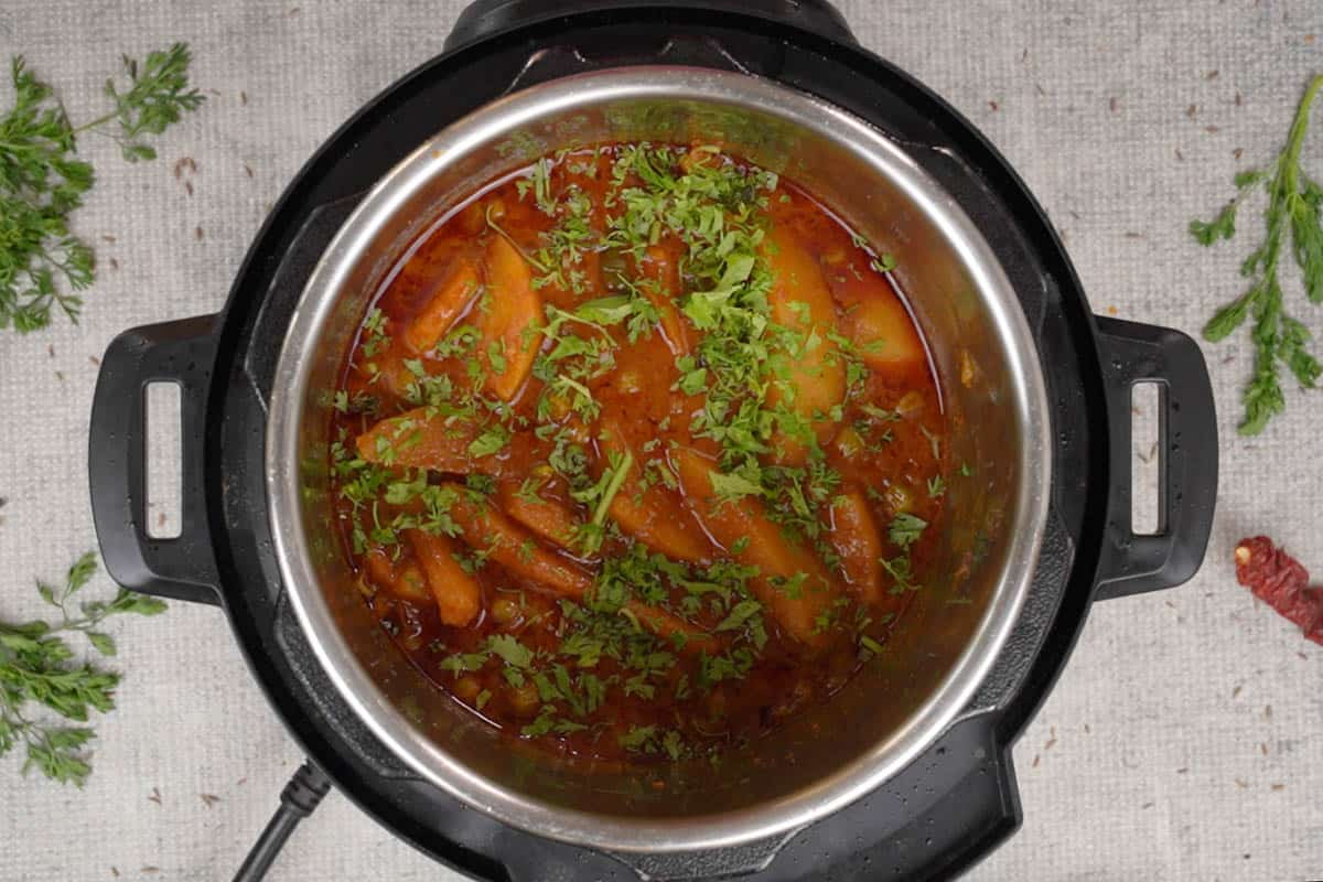 Ready aloo matar curry garnished with coriander.