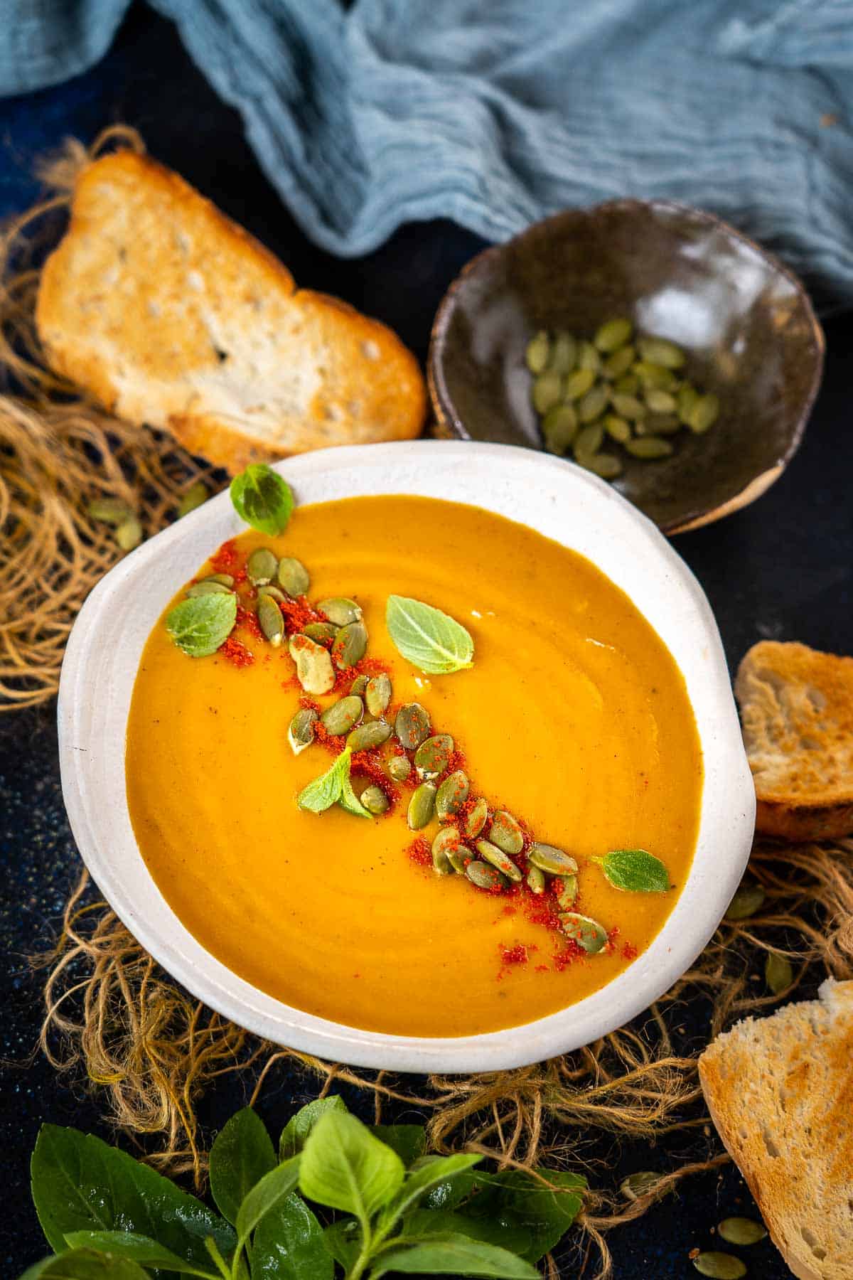 Roasted butternut squash sweet potato soup served in a bowl.