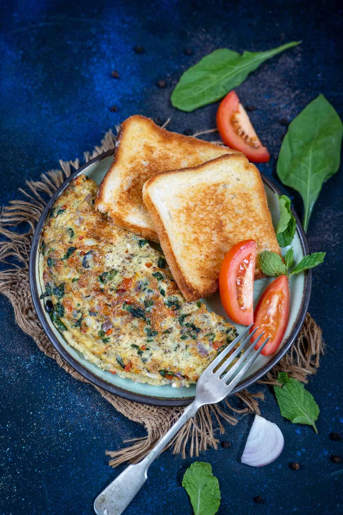 Greek omelette served on a plate with toast.