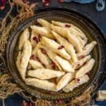 Shakarpara (Shakkar Pare, Khurma, Meetha Para, Toshe) is a North Indian sweet snack. It is basically crispy deep fried all purpose flour cookies coated with thick sugar syrup. Make it for your tea time snack or for festivals like Diwali, Holi, or Rakshabandhan using my perfect recipe.