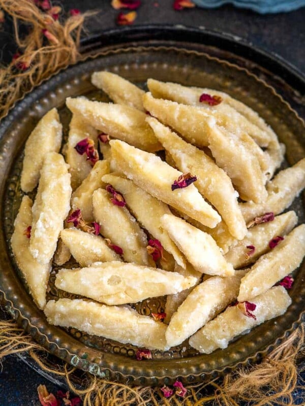Shakarpara (Shakkar Pare, Khurma, Meetha Para, Toshe) is a North Indian sweet snack. It is basically crispy deep fried all purpose flour cookies coated with thick sugar syrup. Make it for your tea time snack or for festivals like Diwali, Holi, or Rakshabandhan using my perfect recipe.