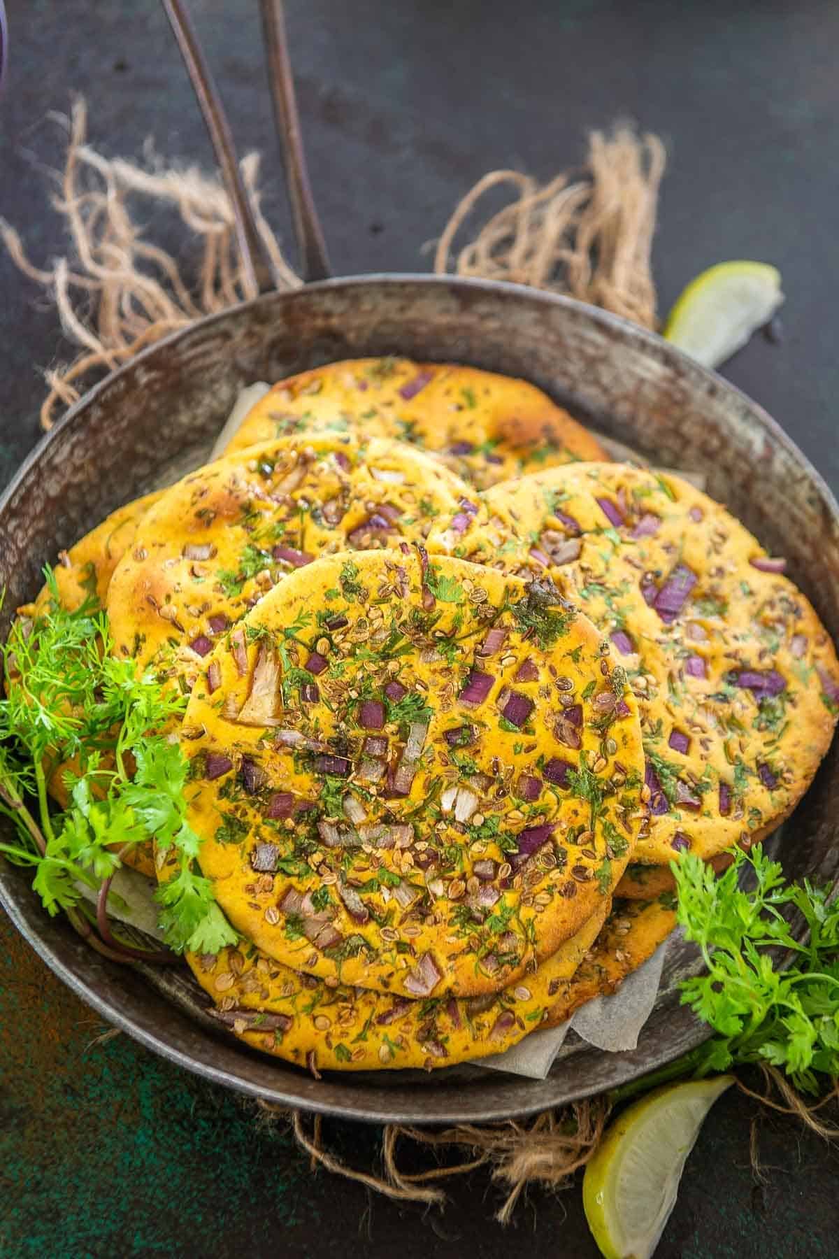 A stack of missi roti in a metal serving plate