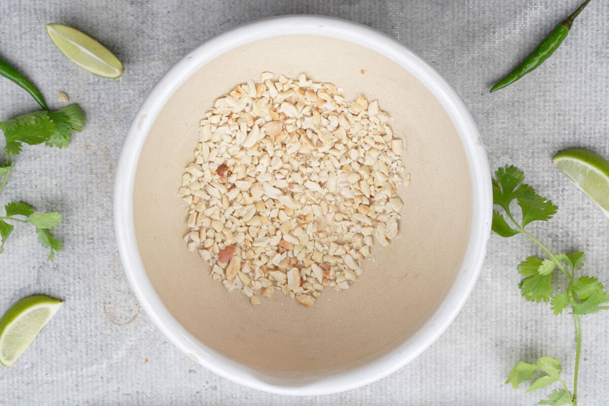 Roasted peanuts crushed in a mortar and pestle.