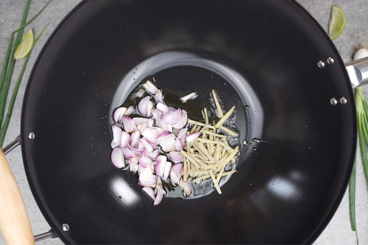 Ginger and shallots added to the wok.