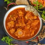 Goan Lamb Vindaloo is a Portuguese-influenced lamb curry where lamb is cooked in a fiery red, spicy and tangy vindaloo sauce. Make it in a traditional stovetop pressure cooker or an instant pot using my easy recipe (gluten-free).