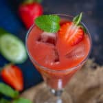 Strawberry cucumber juice served in a glass.
