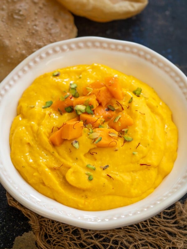 Mango Matho is a Gujurati dessert made using thick yogurt and mangoes. Serve it on its own or with puris for a delicious meal.