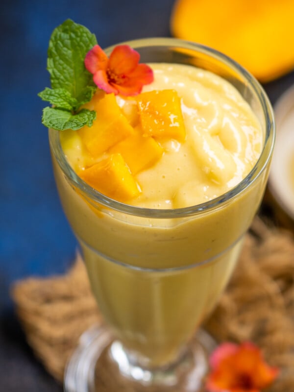 Mango Magic Tropical Smoothie is a delicious drink loaded with tropical flavors. Sip it for breakfast or for snacks (gluten-free, can be easily made vegan).