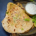 Chilli Cheese Paratha is an Indian stuffed bread with the goodness of cheese and green chilies. Serve it with yogurt and pickle for breakfast or tea time snack.