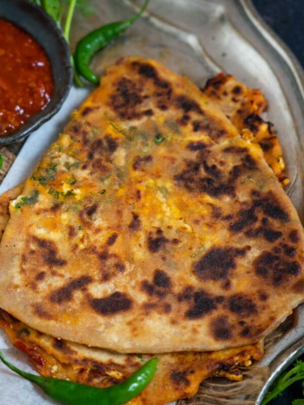 Schezwan Paneer Paratha is an Indian flatbread made using paneer, schezwan sauce, and coriander leaves. Serve it with any chutney of your choice for a hearty breakfast or snack (vegetarian).