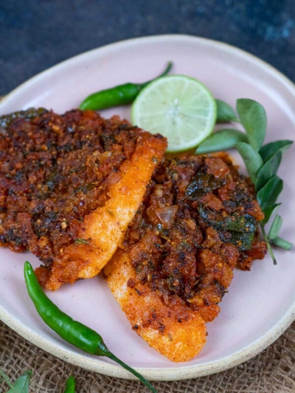 Hyderabadi Spot Idli is a popular street-style recipe, where idli batter is poured on a spicy tomato onion masala and steamed. Try my easy recipe here.