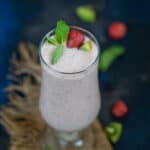 Kiwi quencher tropical smoothie served in a glass.