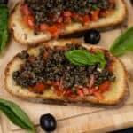 Olive Tapenade Bruschetta is a delicious appetizer that can be made in no time and is sure to be a hit at your house party (vegetarian).