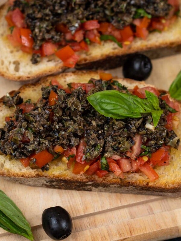 Olive Tapenade Bruschetta is a delicious appetizer that can be made in no time and is sure to be a hit at your house party (vegetarian).