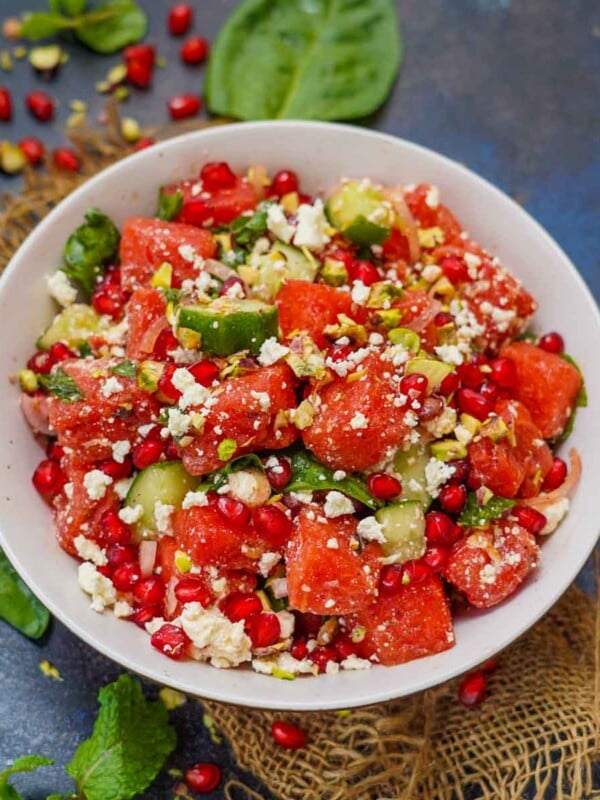Make this refreshing Persian Watermelon Salad using juicy watermelon, cucumber, baby spinach, pomegranate arils, Feta cheese, and a few other simple ingredients (gluten-free).
