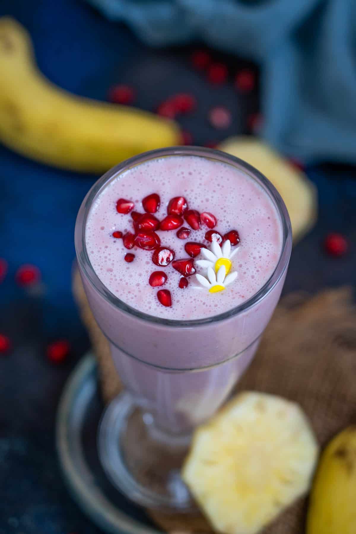 Pomegranate plunge tropical smoothie served in a glass.