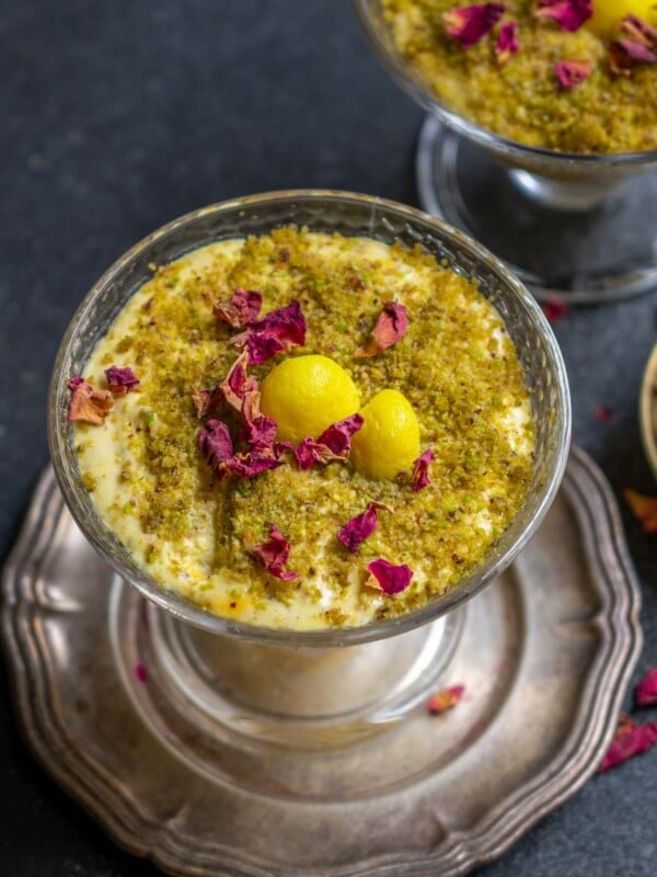 Rasmalai Trifle is a creamy and indulgent fusion dessert prepared with rasmalai flavored whipped cream, rasmalai pieces, sponge cake, and powdered pistachios. Make it this festive season and impress your guests.