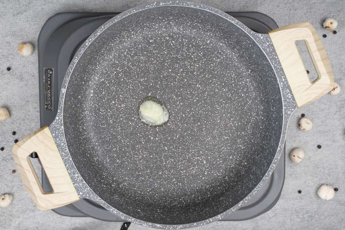 Ghee heating in a pan.